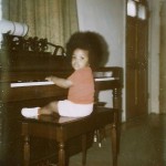 Me as a baby playing the piano with an afro